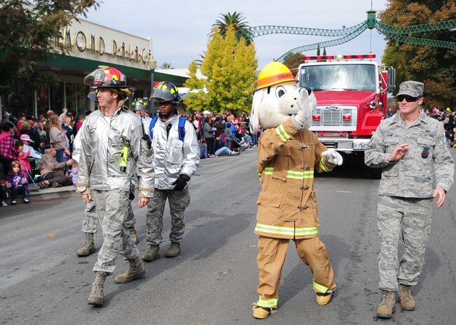 Sparky the Fire Dog waves to local community members attending the Veterans Day Parade in Marysville, Calif., November 11, 2011, while walking with Beale's 9th Civil Engineer Squadron (9th CES) Fire Department. The 9th CES showcased fire trucks, explosive ordinance disposal equipment and personal protective equipment throughout the parade route. (U.S. Air Force photo by Airman 1st Class Shawn Nickel)