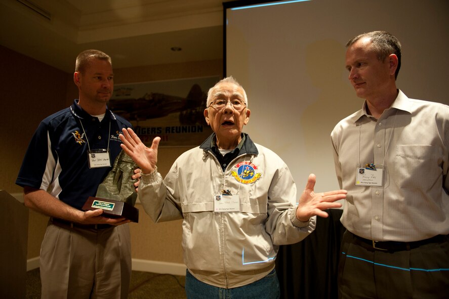 Retired Chinese air force Maj. Gen. Fred Wu-O Chiao gives remarks after presenting a gift to U.S. Air Force Col. Ronald Stuewe, 23rd Fighter Group commander, left, and Col. Billy Thompson, 23rd Wing commander, during the 2011 Flying Tigers Reunion in Tampa, Fla., Nov. 11, 2011. Chiao graduated from the China Air Force Academy in 1940 and flew with the American Volunteer Group against Japanese forces during World War II. During his speech, Chiao spoke about retired U.S. Army Air Corps Lt. Gen. Claire Lee Chennault and his experiences with the Flying Tigers. (U.S. Air Force photo by Staff Sgt. Jamal D. Sutter/Released)