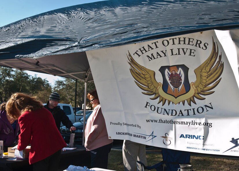 Members of the That Others May Live Foundation set up a booth in honor of National Roll Call for Veterans Day in front of West Hall at Valdosta State University on Nov. 11, 2011. The TOML Foundation provides scholarships, counseling and aid to surviving children of U.S. Air Force rescue heroes who gave their lives during duty. The TOML Foundation also participates in a community ambassadors program where fundraising events are held for care packages to be sent to deployed military members. (U.S. Air Force photo by Senior Airman Eileen Meier/Released)