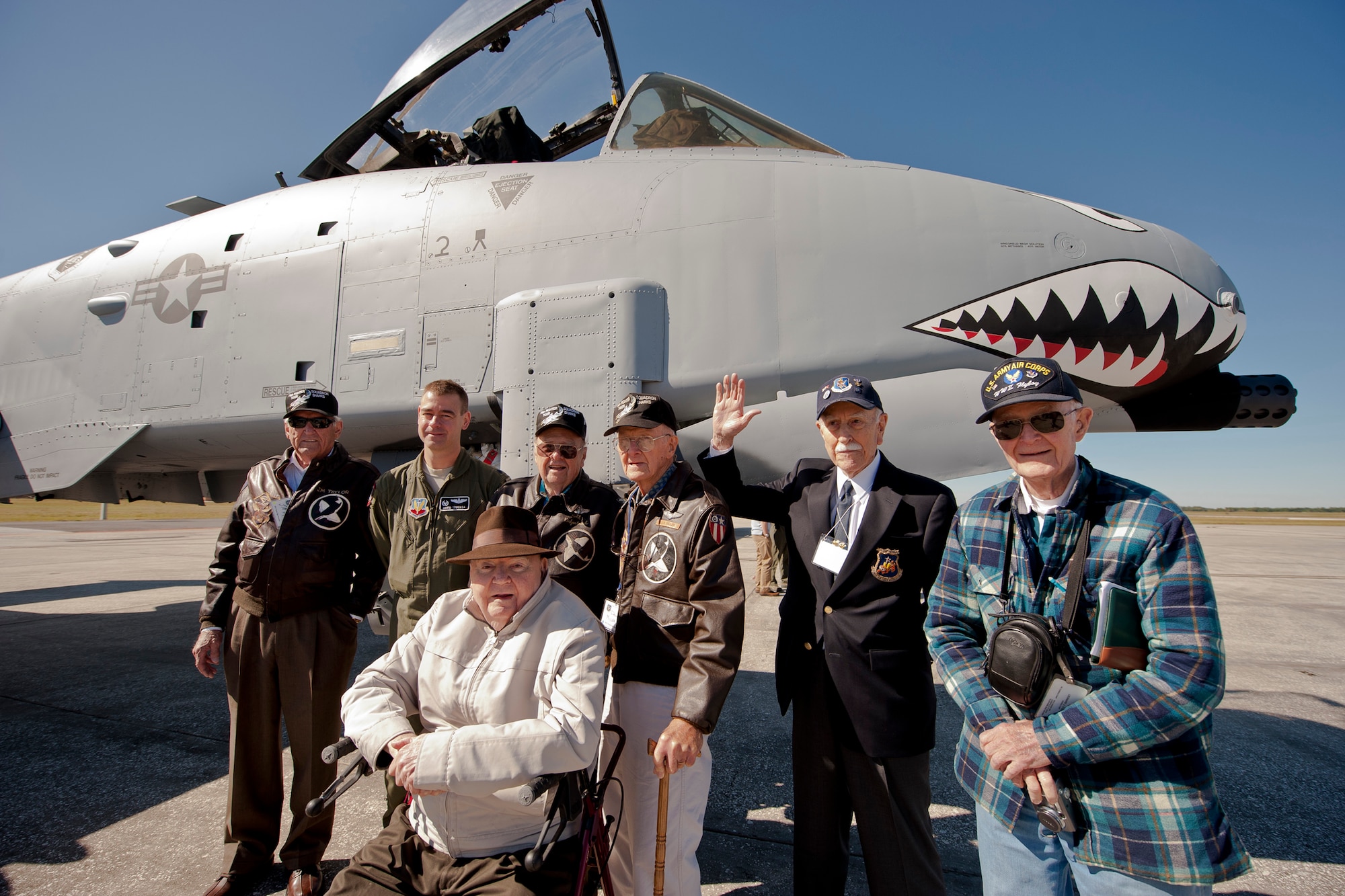Past and present Flying Tigers gather next to an A-10C Thunderbolt II during the 2011 Flying Tigers Reunion at MacDill Air Force Base, Fla., Nov. 11, 2011. During World World II, the original Flying Tigers famously painted shark teeth on P-40s, a tradition still followed and used on today's A-10s within the 23rd Fighter Group. (U.S. Air Force photo by Staff Sgt. Jamal D. Sutter/Released)