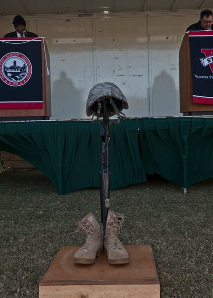 A traditional display of boots, dog tags, M-16 assault rifle and kevlar is set up as a memorial during National Roll Call in honor of Veterans Day in front of West Hall at Valdosta State University, Valdosta, Ga., Nov.11, 2011. VSU staff, faculty, students and members of the community volunteered to read from the list of 6,274 casualties who lost their lives in service to America in operations in Afghanistan and Iraq.  Colleges and universities all over the United States, including D.C., participated in the event and paused at 11 a.m. for a moment of silence. (U.S. Air Force photo by Senior Airman Eileen Meier/Released)