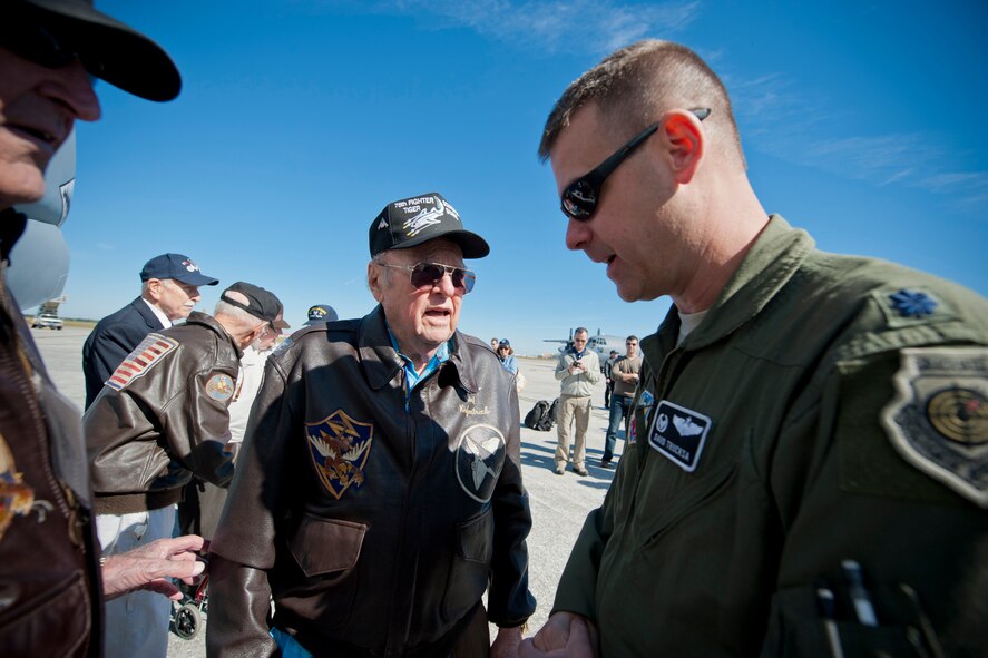 Retired U.S. Air Force Col. Kirk Kirkpatrick, World War II era 75th Fighter Squadron pilot, speaks with Lt. Col. David Trucksa, 75th Fighter Squadron commander, during the 2011 Flying Tigers Reunion at MacDill Air Force Base, Fla., Nov. 11, 2011. Trucksa showcased an A-10C Thunderbolt II during a static display which also included an HC-130P Combat King and an HH-60G Pave Hawk. (U.S. Air Force photo by Staff Sgt. Jamal D. Sutter/Released)