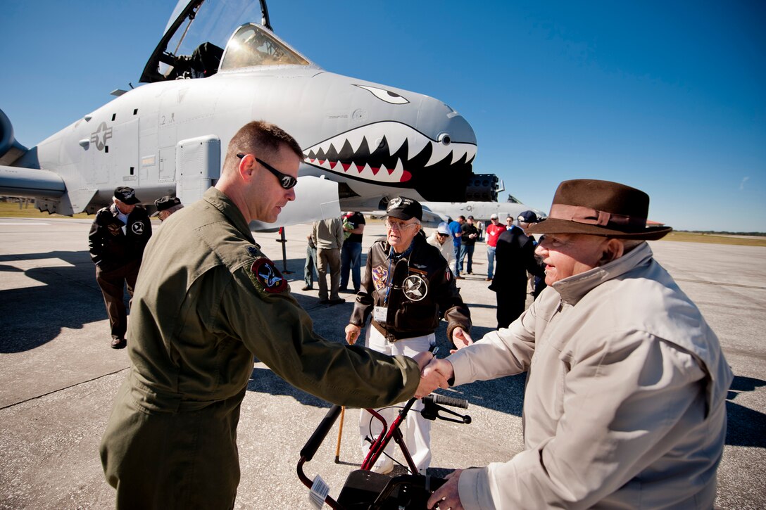 U.S. Air Force Lt. Col. David Trucksa, 75th Fighter Squadron commander, shakes hands with retired Col. Frank Epperson, World War II era 75th FS pilot, during the 2011 Flying Tigers Reunion at MacDill Air Force Base, Fla., Nov. 11, 2011. The reunion was a three-day event which included briefings, static displays, guest speakers and a dinner. (U.S. Air Force photo by Staff Sgt. Jamal D. Sutter/Released) 