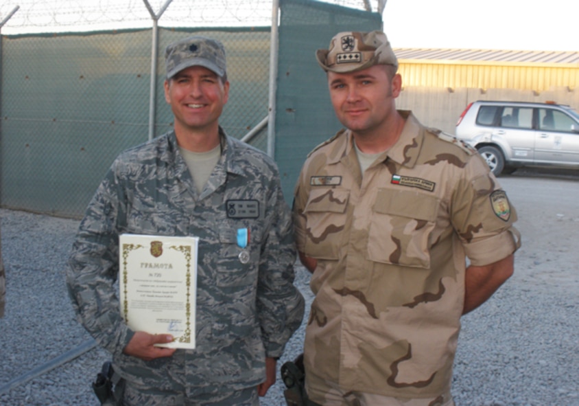 Lt. Col. Timothy Martz, 94th Security Forces Squadron commander, is awarded a Bulgarian Mission Medal by order of the Minister of Defense of the Republic of Bulgaria while deployed as Chief Base Security and Base Security Group commander in Kandahar Afghanistan. Martz commanded 295 Bulgarian servicemembers as part of the Base Security Group and base perimeter defenses. (Courtesy photo)
