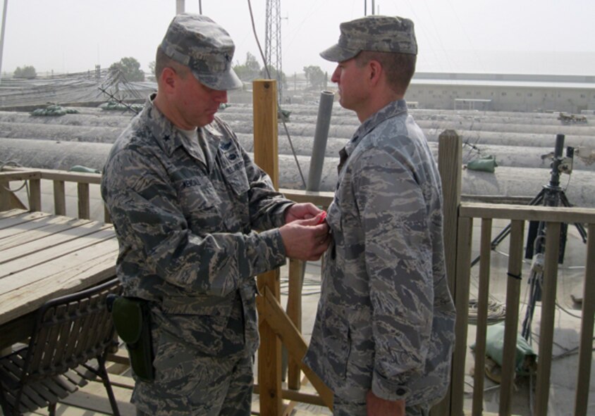 Brig. Gen. Jeffrey B. Kendall, commander, Kandahar Airfield, Afghanistan, presents Lt. Col. Timothy Martz, 94th Security Forces Squadron commander, with the Bronze Star Medal for exceptionally meritorious service in direct support of combat operations while deployed as Chief Base Security and Base Security Group commander in Kandahar Afghanistan. While assigned to the NATO Command Kandahar Airfield (COMKAF) Headquarters, Martz commanded over 700 personnel from 9 nations. Their primary mission was to protect and defend Kandahar Airfield from insurgent attacks. (Courtesy photo)