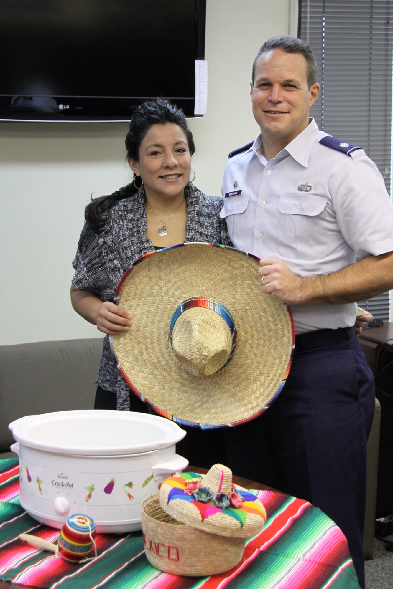 Lt. Col. Lowell “Buzz” Bingham and his wife, Miroslava “Bon” Bingham, proudly show-off the Mexican-themed decorations that they displayed with their winning chicken enchilada soup. The couple’s soup won first place in the 911th Airlift Wing’s 1st Combined Federal Campaign Chili/Soup Cook-Off, Nov. 4. (U.S. Air Force Photo/By Senior Airman Jonathan Hehnly)