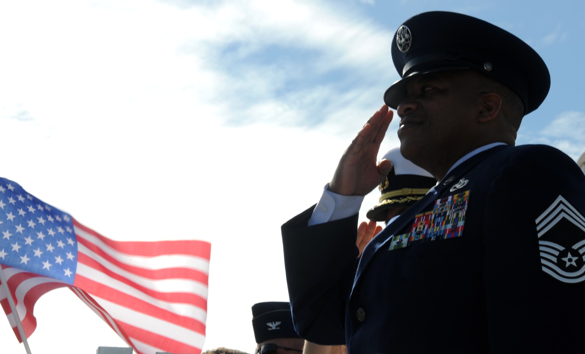 Chief Master Sgt. Curtis Jennings, 81st Mission Support Group superintendent, salutes as the flag passes the reviewing stand during the 11th Annual Gulf Coast Veterans Day Parade in D’Iberville, Miss., Nov. 12, 2011.  (U.S. Air Force photo by Kemberly Groue)