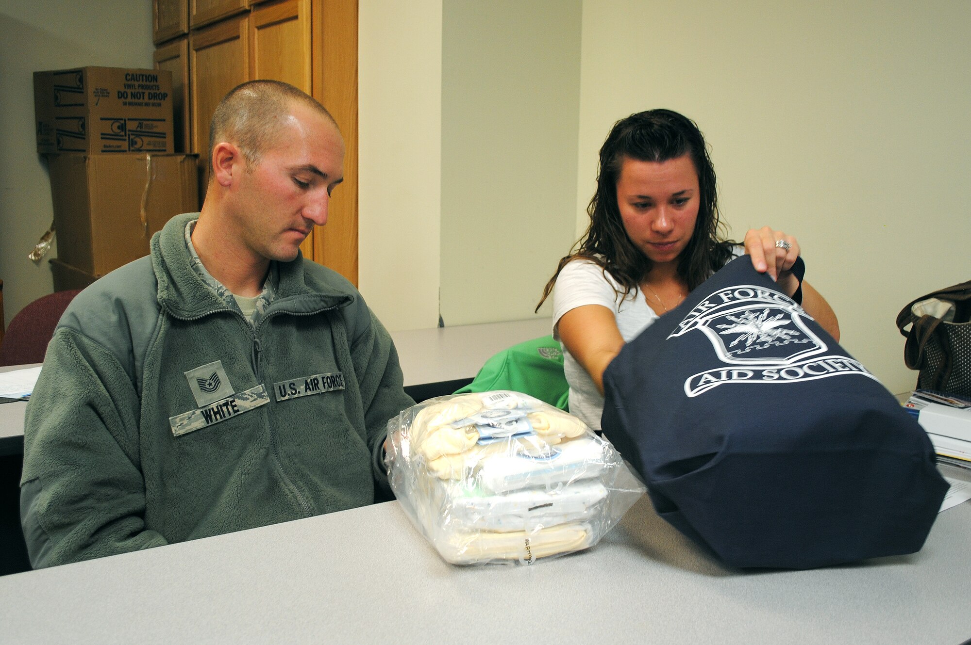 Tech. Sgt. Jason White, 341st Missile Wing WSA escort supervsior, and his wife, Amber, sort through the complimentary bag of goodies handed out at the end of a Bundles for Babies class. The monthly, two-hour class for new parents consists of presenters and videos covering a range of topics including safe sleeping and budgeting. The class also offers a free assortment of items such as crib sheets, thermal blankets, mittens, botties, bibs, shirts and bath towels to the parents who attend. The next class is scheduled for Nov. 16 at the Airman and Family Readiness Center. For more information or to sign up, call the AFRC at 731-4900.