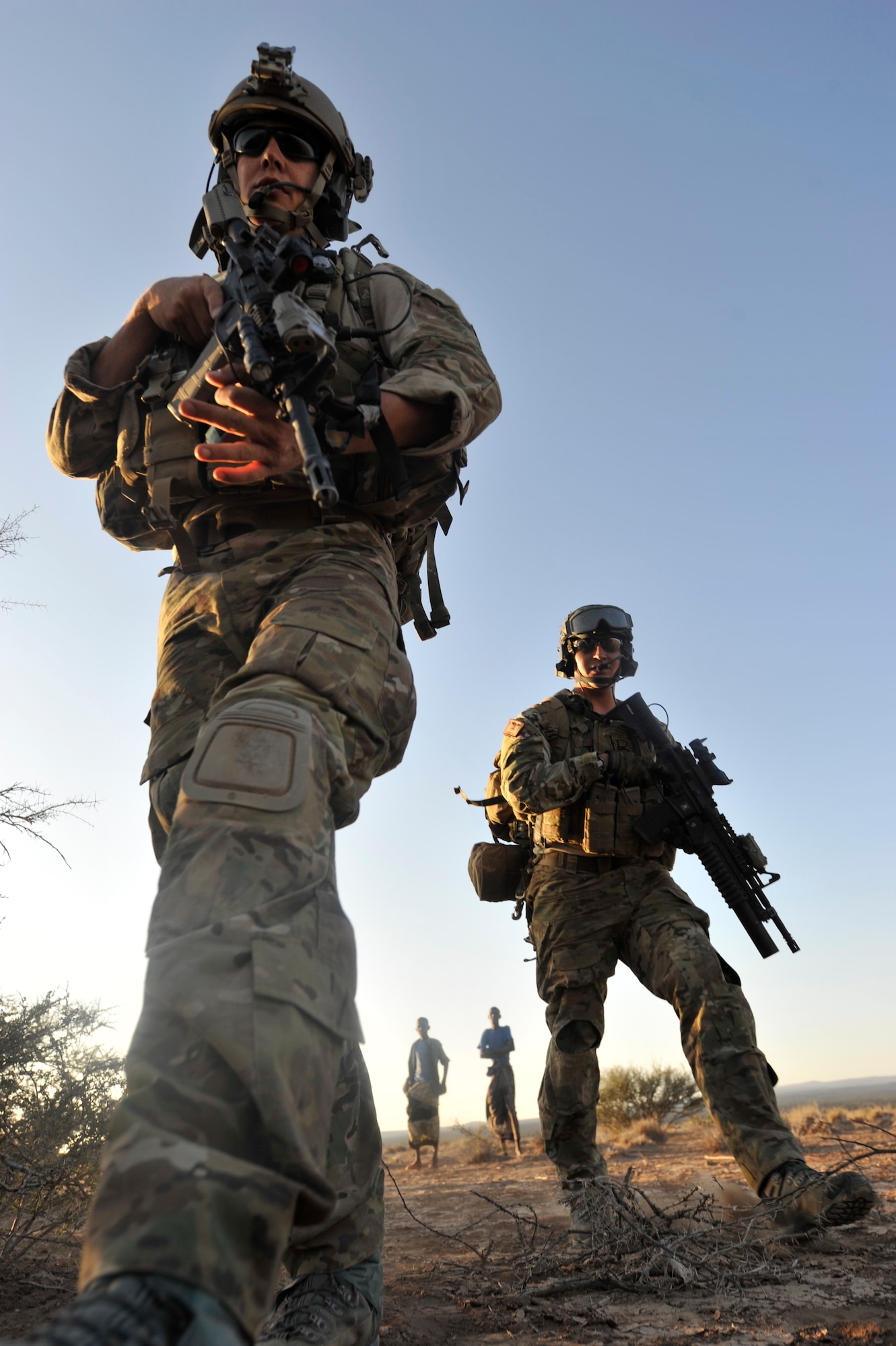 Senior Airman Eric Humphrey (left) and Staff Sgt. Andrew Rios, both 82nd Expeditionary Rescue Squadron pararescuemen, arrive on scene to attend to simulated casualties at a mock crash site during a training mission in the Grand Bara Desert, Djibouti, Oct. 21, 2011. After parachuting into the drop zone, Rios' team had to locate casualties, provide care and evacuate them to safety as a part of the scenario. (U.S. Air Force photo/Staff Sgt. Renae Saylock)