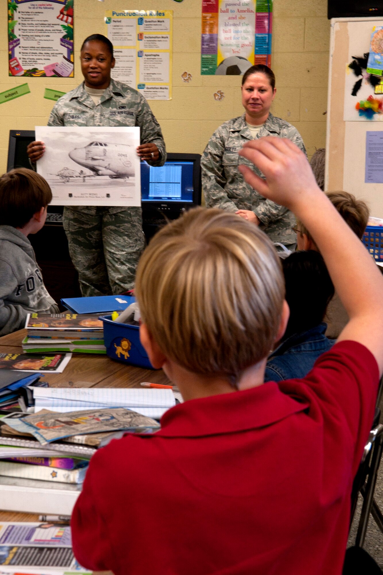 U.S. Air Force Staff Sgts. Crystal Chiles and Julie Daggett, 917th Aircraft Maintenance Squadron avionics technicians, talk to a group of Phoenix Magnet Elementary School students during a visit on Nov. 10, 2011. The school hosted a group of 917th Fighter Group personnel, who visited all 675 students, answering questions about themselves, their jobs and the Air Force Reserve. (U.S. Air Force photo by Master Sgt. Greg Steele/Released)