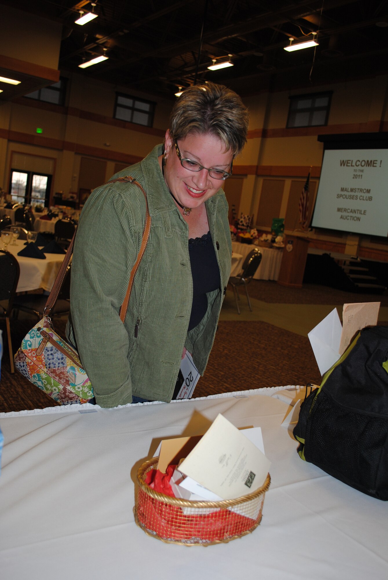 Ginger Murphy eyes a box of goodies at the 23rd Annual mercantile Auction Nov. 5. (U.S. Air Force photo/Airman 1st Class Katrina Heikkinen)