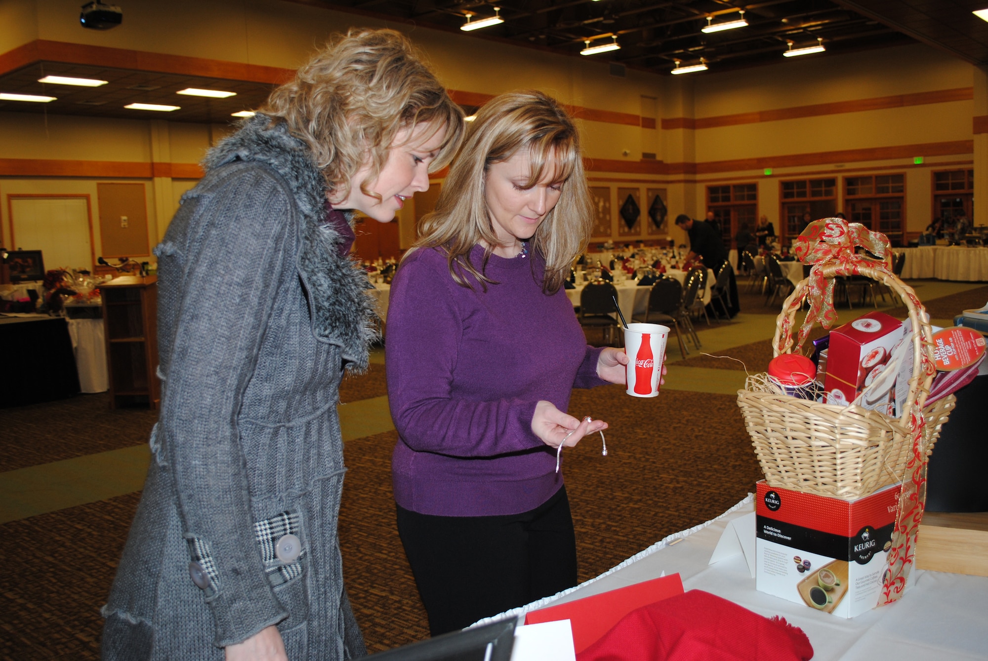 Amy Gibbons, left, and Amber Plant, members of the Malmstrom Spouses' Club look at a piece of jewelry on display. The annual fundraiser is put on by the Malmstrom Spouses' Club. (U.S. Air Force photo/Airman 1st Class Katrina Heikkinen)