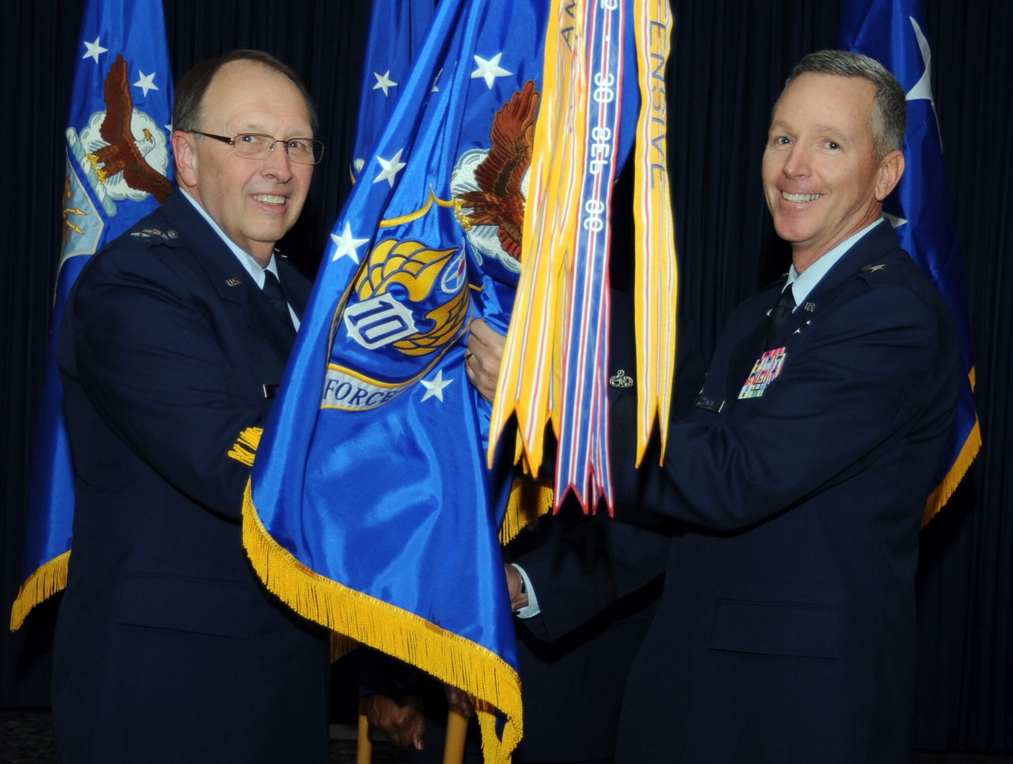 Lt. Gen. Charles E. Stenner, Jr., chief of Air Force Reserve, and commander, Air Force Reserve Command, passes the 10th Air Force flag to Brig. Gen. William Binger who assumed command of 10th AF at Naval Air Station Fort Worth Joint Reserve Base, Texas Nov. 5.  Binger assumed command from Maj. Gen. Frank J. Padilla, who transferred to the Pentagon as the Air Force deputy inspector general. (U.S. Air Force photo/Master Sgt. Julie Briden-Garcia)