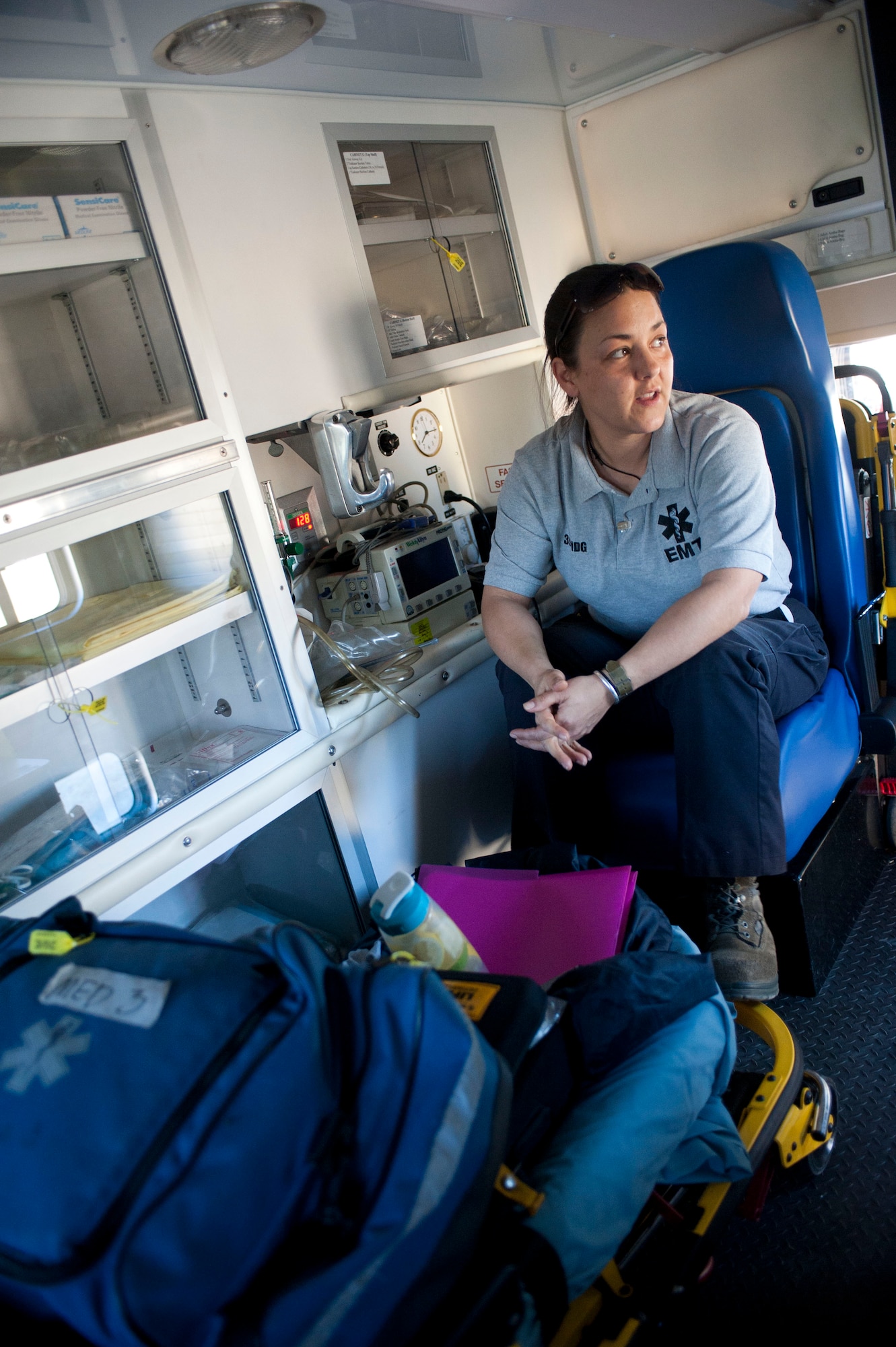 Staff Sgt. Tracy Metcalf, 39th Medical Group ambulance services medical technician, rides in the back of an ambulance after updating its radio Nov. 9, 2011, at Incirlik Air Base, Turkey. Ambulance services technicians respond to medical emergencies and care for patients while transporting them to a hospital off base. (U.S. Air Force photo by Senior Airman Clayton Lenhardt/Released)