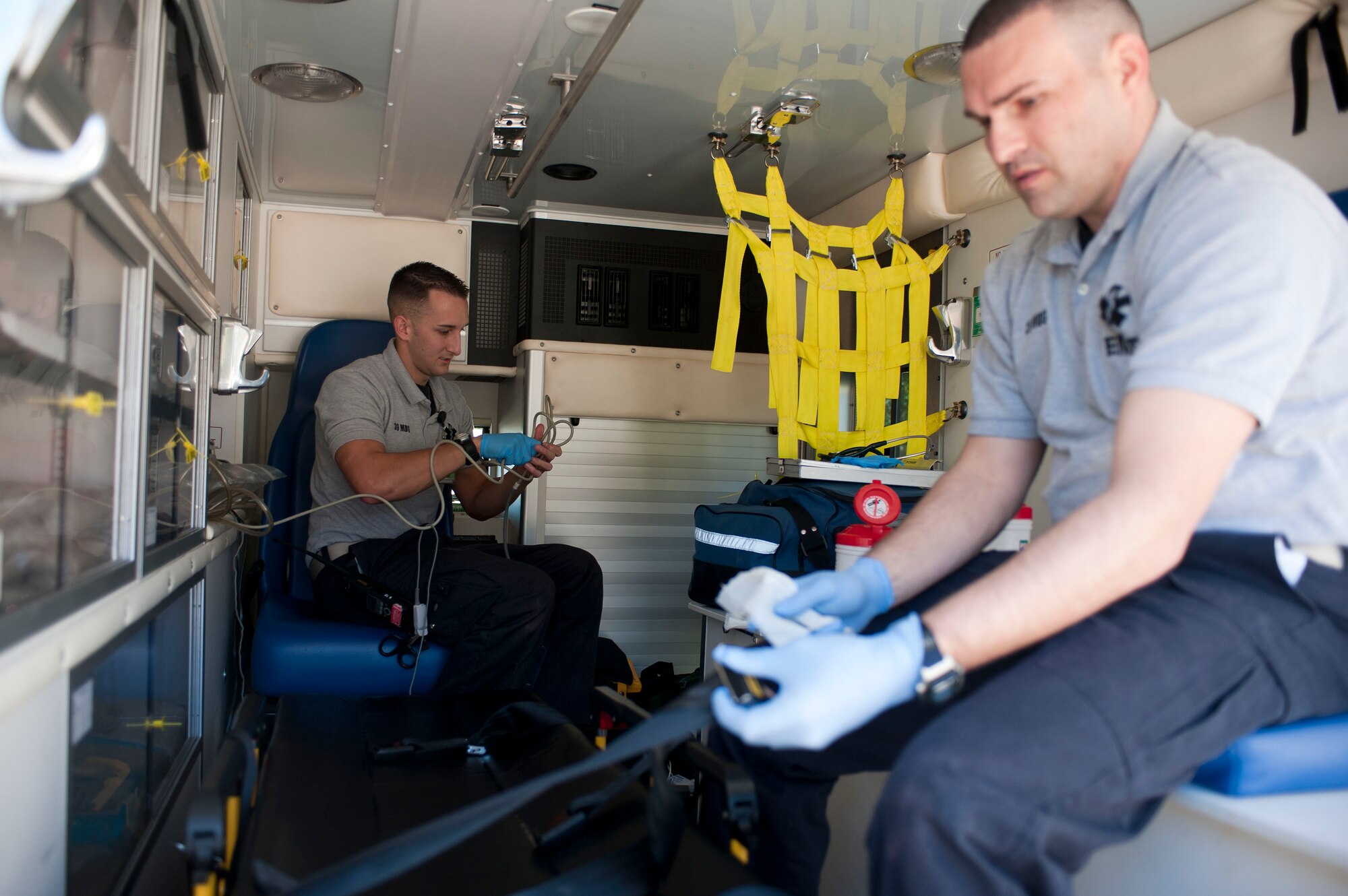 Staff Sgts. Dominic Ancona, left, and Tommy Bender, both 39th Medical Group ambulance services medical technicians, clean the back of an ambulance after receiving a call Nov. 8, 2011, at Incirlik Air Base, Turkey. Ambulance services technicians respond to medical emergencies and care for patients while transporting them to a hospital off base. (U.S. Air Force photo by Senior Airman Clayton Lenhardt/Released)