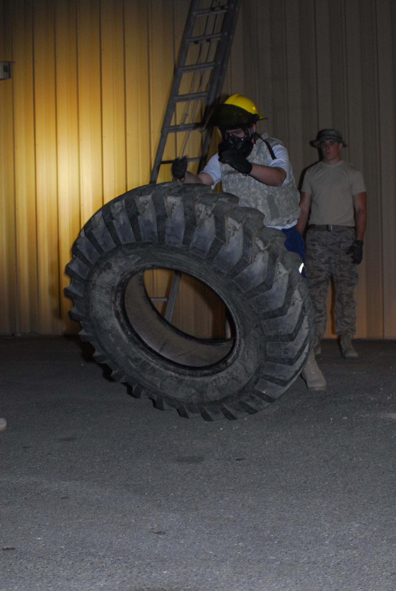 Airman 1st Class Tyler Streetman, 332nd Expeditionary Maintenance Squadron maintainer, turns a tire while participating in a firefighter challenge at an undisclosed location in Southwest Asia Nov. 11, 2011. Firefighters assigned to the 332nd Expeditionary Civil Engineer Squadron hosted the timed physical event in conjunction with Veterans Day. Streetman is deployed from Shaw Air Force Base, S.C., and is a native of Rockmart, Ga. (U.S. Air Force photo by 1st Lt. Rusty Ridley)
