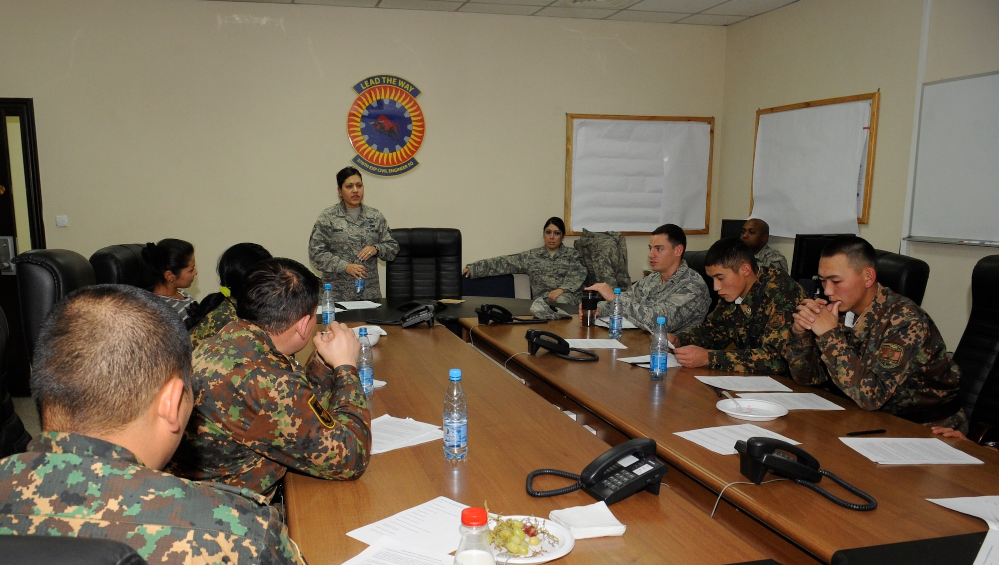 Soldiers from Koi Tash listen as Master Sgt. Leenette Joseph explains what Airmen learn in Airman Leadership School during an enlisted professional military education instructor exchange at the Transit Center at Manas, Kyrgyzstan, Nov. 10. Joseph, who spent three years as an ALS instructor, is assigned to the 376th Air Expeditionary Wing Equal Opportunity Office as the director. She is deployed from Barksdale Air Force Base, La. (U.S. Air Force photo/Tech. Sgt. Tammie Moore)
