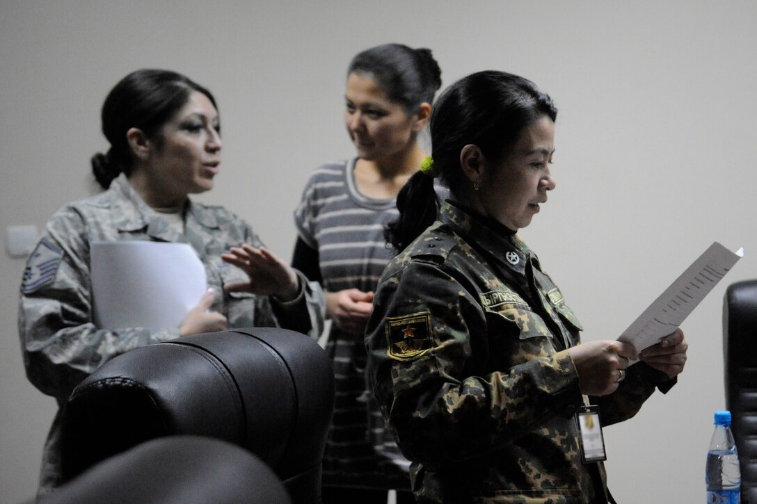 Kyrgyz Republic Chief Warrant Officer Ayzada Shamirkanova reads a communications exercise out loud during an enlisted professional military education instructor exchange at the Transit Center at Manas, Kyrgyzstan, Nov. 10. Shamirkanova is an instructor at the Koi Tash Noncommissioned Officer Academy. (U.S. Air Force photo/Tech. Sgt. Tammie Moore)