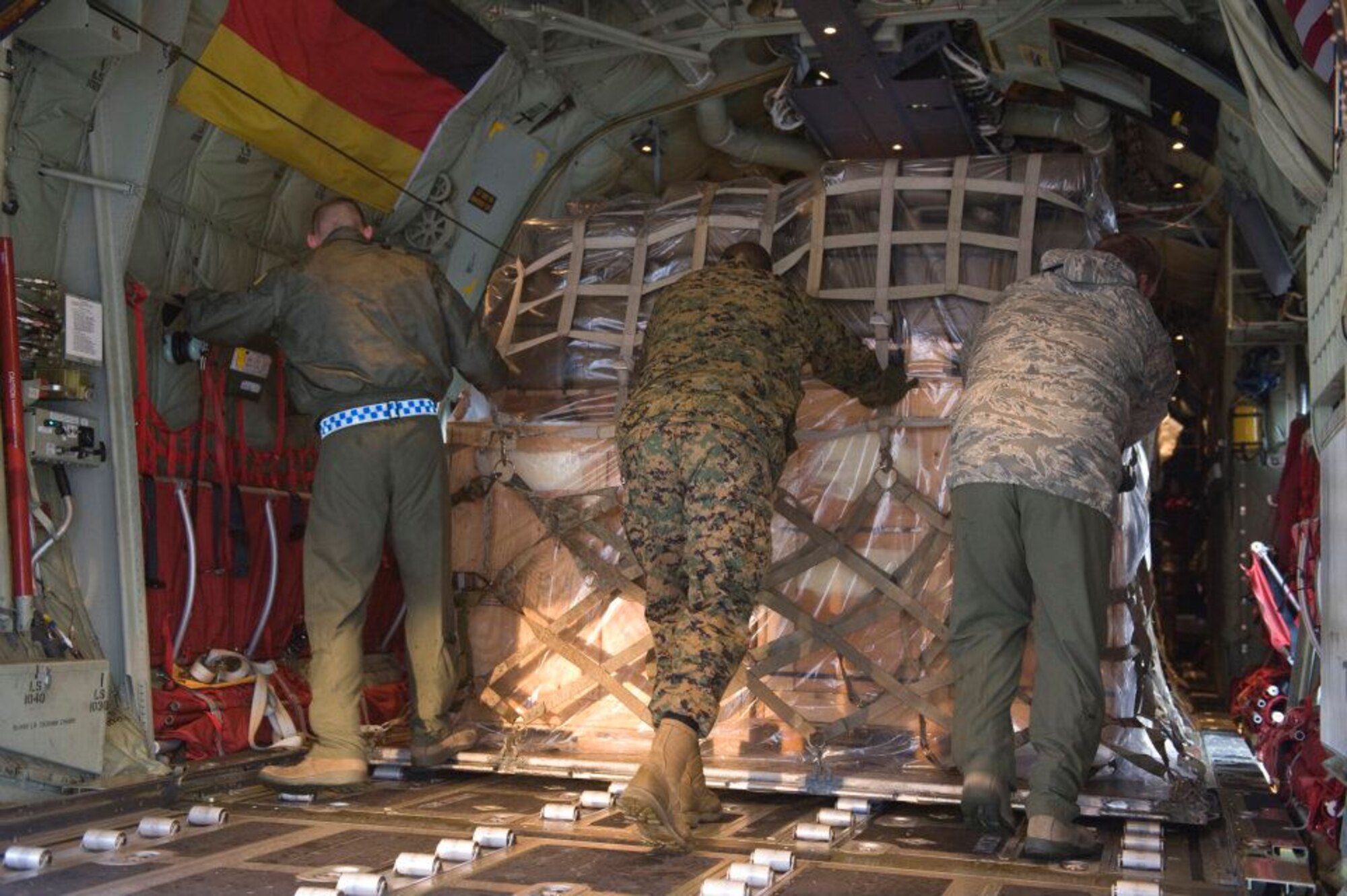 Members of the 37th Airlift Squadron, Norwegian Defense Logistic Organization/Marine Expeditionary Brigade and Marine Forces Europe load a C-130J Hercules aircraft with pallets of humanitarian supplies for transportation in Stjordal, Norway, Nov. 14, 2011. The effort is in support of the Turkey-led relief efforts following the Nov. 9, and Oct. 23, 2011, earthquake in Van province, Turkey. At the request of the Turkish government the Department of Defense has tasked U.S. European Command to airlift relief supplies to Van province. (U.S. Air Force photo/MSgt Wayne Clark, AFNE Regional News Bureau) (Released) Defense Media Activity