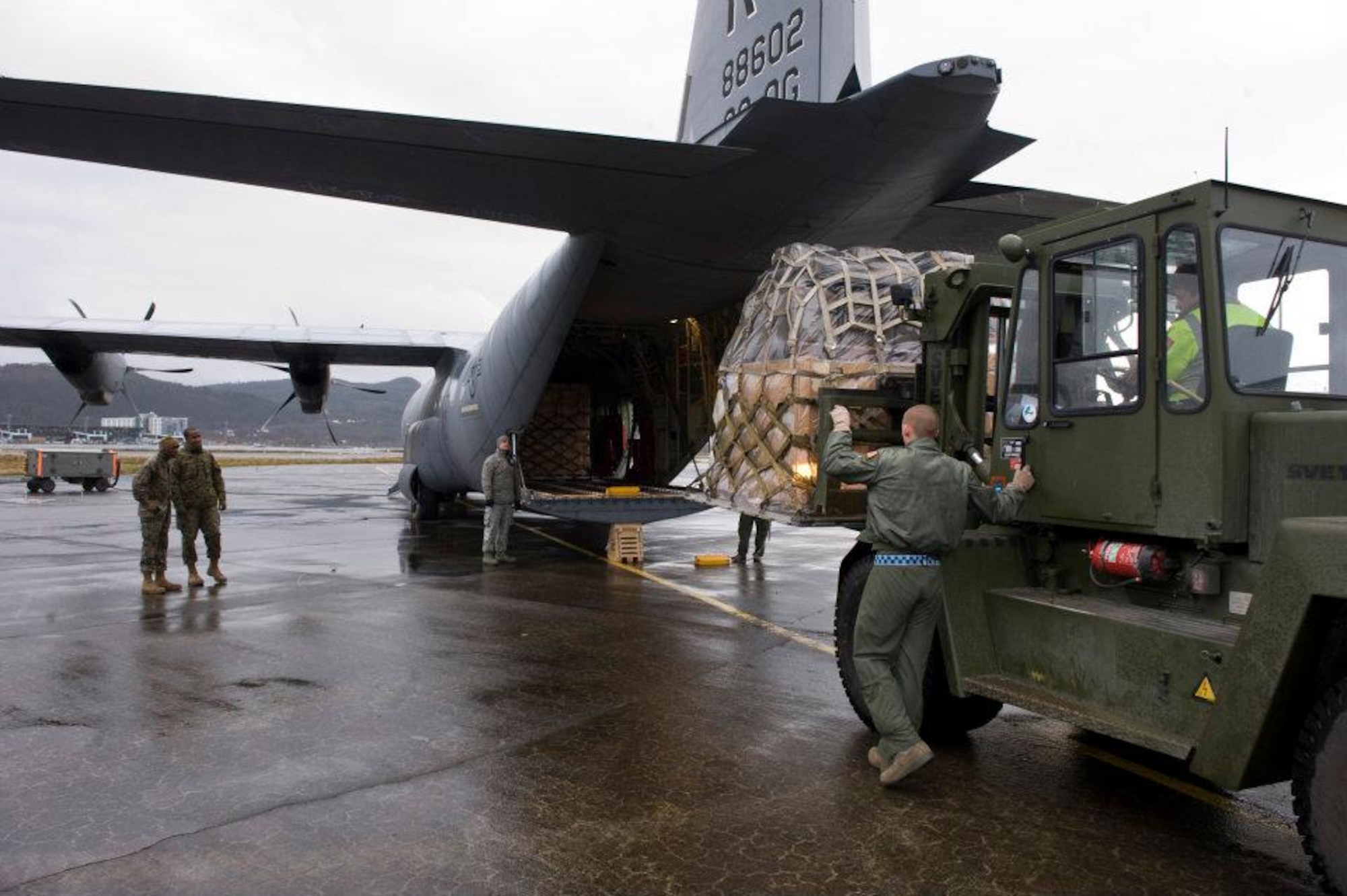 Members of the 37th Airlift Squadron, Norwegian Defense Logistic Organization/Marine Expeditionary Brigade and Marine Forces Europe load a C-130J Hercules aircraft with pallets of humanitarian supplies for transportation in Stjordal, Norway, Nov. 14, 2011. The effort is in support of the Turkey-led relief efforts following the Nov. 9, and Oct. 23, 2011, earthquake in Van province, Turkey. At the request of the Turkish government the Department of Defense has tasked U.S. European Command to airlift relief supplies to Van province. (U.S. Air Force photo/MSgt Wayne Clark, AFNE Regional News Bureau) (Released) Defense Media Activity