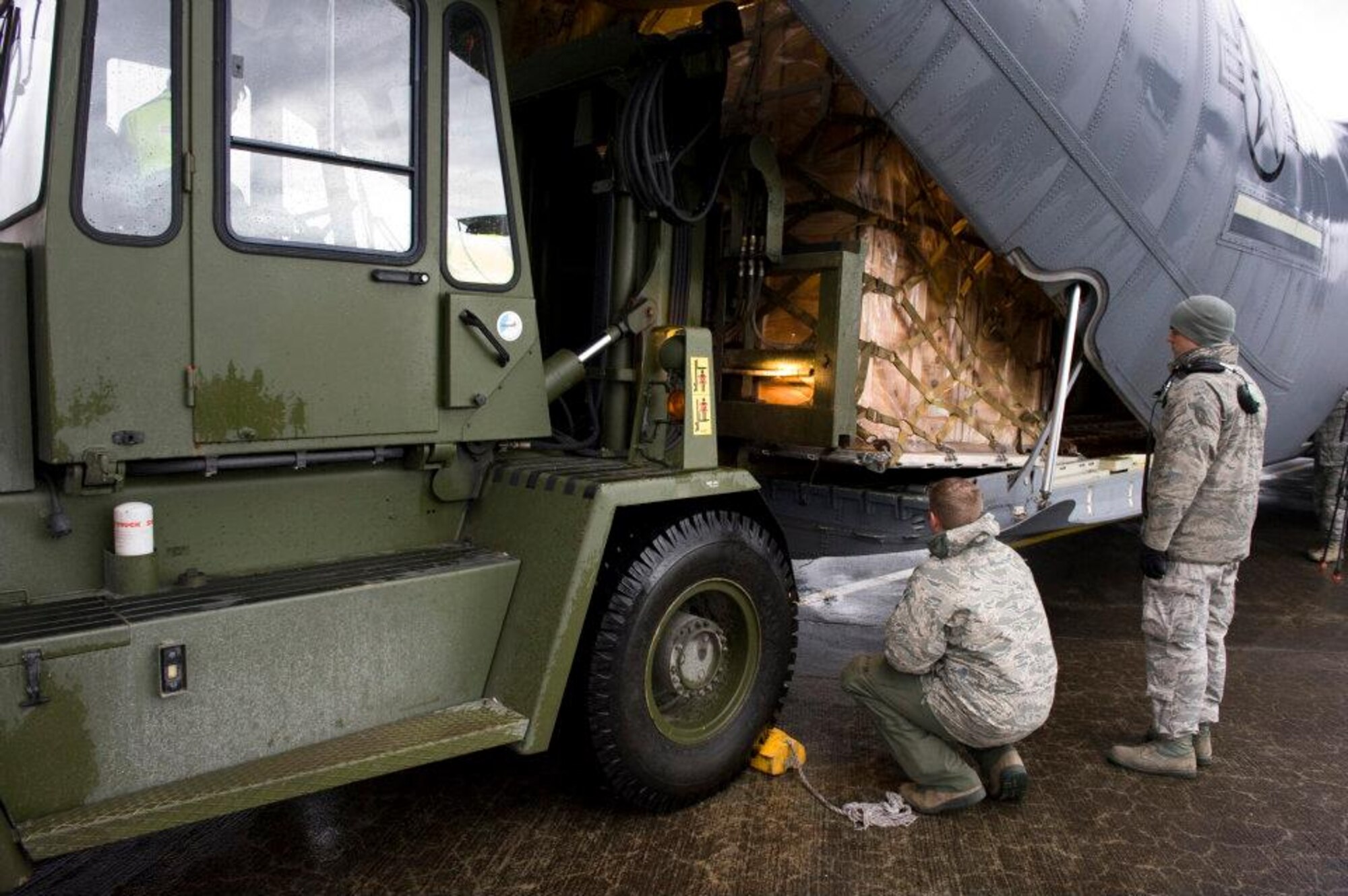 Members of the 37th Airlift Squadron, Norwegian Defense Logistic Organization/Marine Expeditionary Brigade and Marine Forces Europe load a C-130J Hercules aircraft with pallets of humanitarian supplies for transportation in Stjordal, Norway, Nov. 14, 2011. The effort is in support of the Turkey-led relief efforts following the Nov. 9, and Oct. 23, 2011, earthquake in Van province, Turkey. At the request of the Turkish government the Department of Defense has tasked U.S. European Command to airlift relief supplies to Van province. (U.S. Air Force photo/MSgt Wayne Clark, AFNE Regional News Bureau) (Released) Defense Media Activity