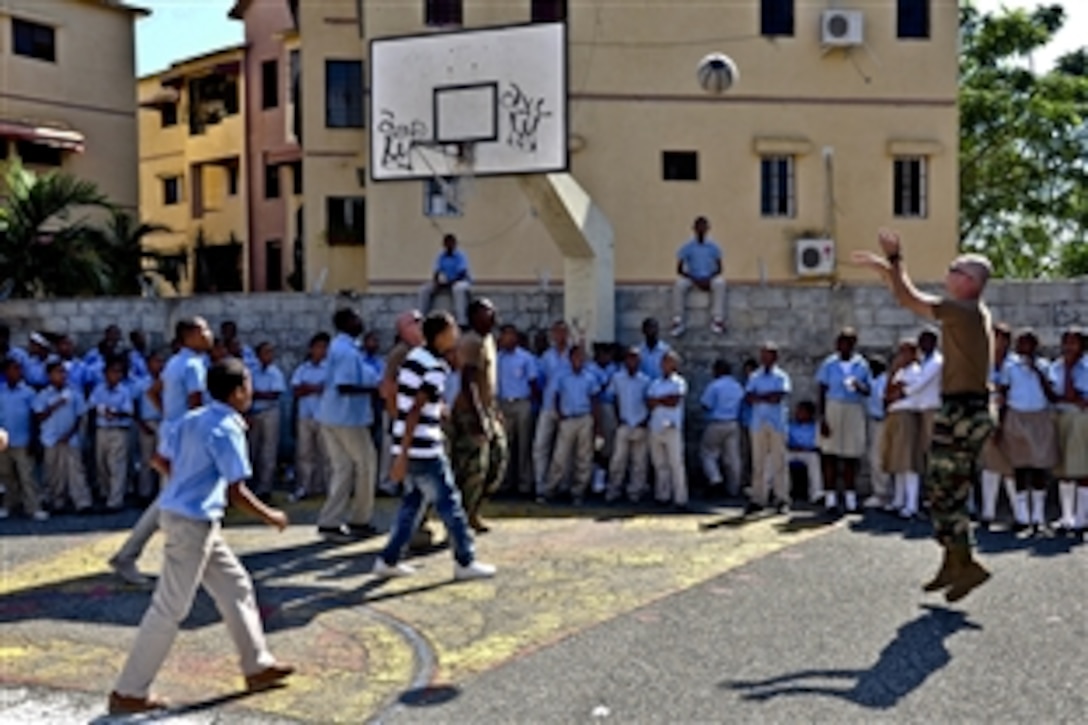 U.S. Navy Seabees play basketball with students from Basica Rafaela Santaella school during a community service project supporting Southern Partnership Station 2012 in Santo Domingo, Dominican Republic, Nov. 11, 2011. The seabees are assigned to Naval Mobile Construction Battalion 23. Southern Partnership Station is an annual deployment of U.S. ships to the U.S. Southern Command area of responsibility in the Caribbean, Central and South America.  