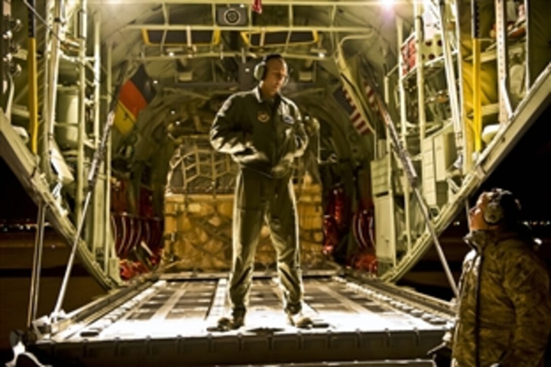 U.S. Air Force Airman 1st Class Christopher Dysert and Staff Sgt. Glen Scott discuss their mission while waiting to unload a C-130J Hercules aircraft with pallets of humanitarian supplies from Stjordal, Norway in Van province, Turkey, Nov. 15, 2011. Dysert and Scott are assigned to the 37th Airlift Squadron. The mission is being conducted in support of the Turkey-led relief efforts following recent earthquakes in Van province, Turkey. At the request of the Turkish government the Defense Departme