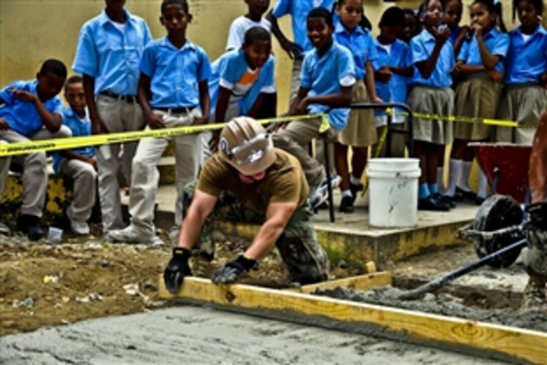 U.S. Navy Seabee Justin Holden smoothes and levels wet cement at Basica Rafaela Santaella school during a community service project supporting Southern Partnership Station 2012 in Santo Domingo, Dominican Republic, Nov. 11, 2011. Holden is an equipment operator assigned to Naval Mobile Construction Battalion 23. Southern Partnership Station is an annual deployment of U.S. ships to the U.S. Southern Command area of responsibility in the Caribbean, Central and South America.  