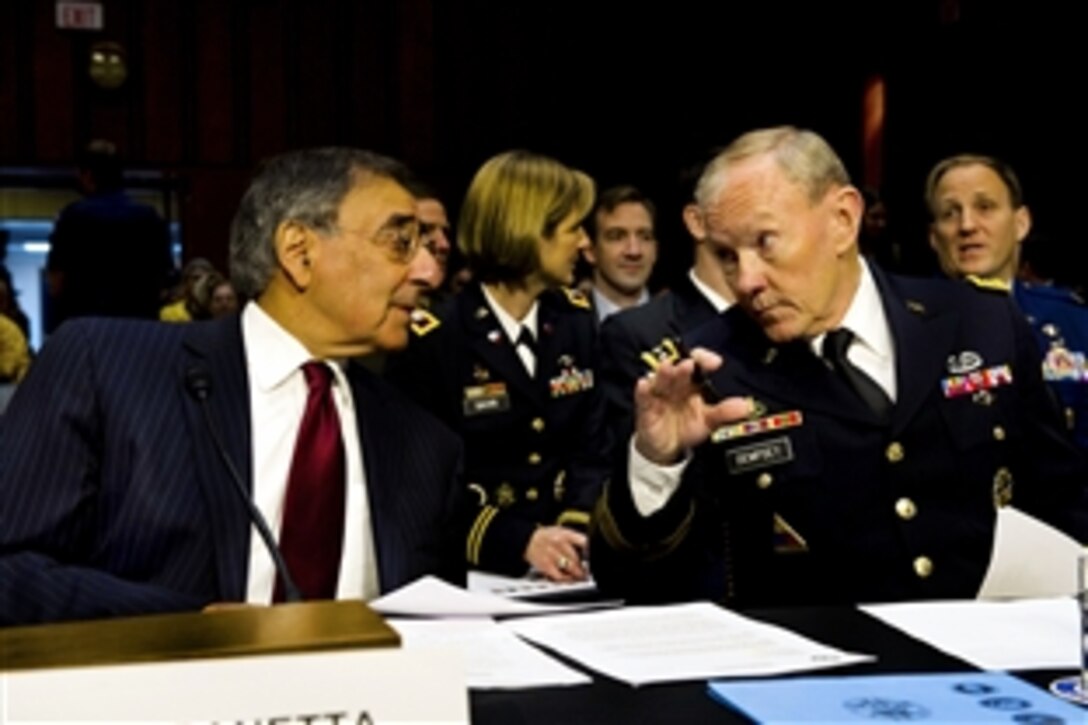 Defense Secretary Leon E. Panetta and Army Gen. Martin E. Dempsey, chairman of the Joint Chiefs of Staff, speak before giving testimony to the Senate Armed Services Committee, Nov. 15, 2011. Panetta and Dempsey discussed the withdrawal of U.S. troops from Iraq, scheduled to conclude by the end of the year. 