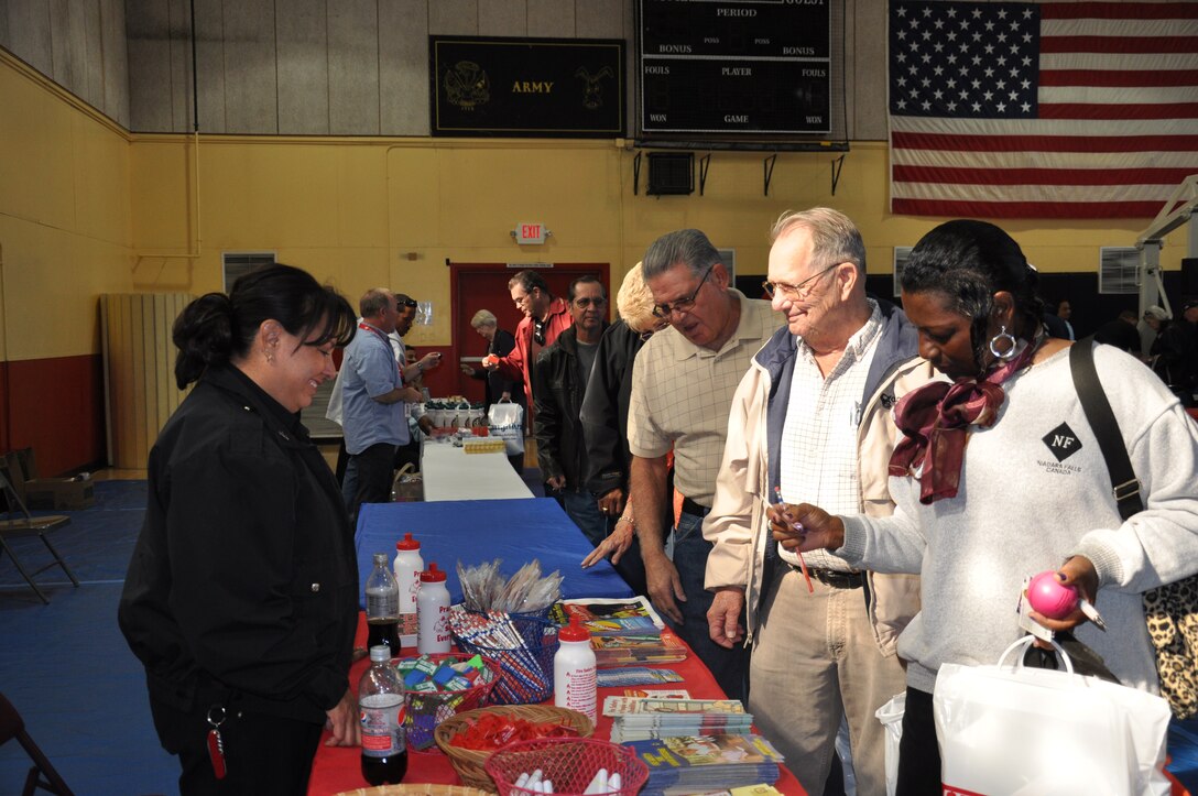 Joanne Williams (left), fire inspector, Marine Corps Fire Department, MCLB Barstow, offers advice to retirees on services available to them through the fire department.