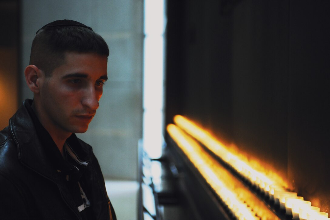 Petty Officer 3rd Class Gary Facteau, Marine Barracks Washington hospital corpsman, takes a moment to reflect on the atrocities of the Holocaust in the Hall of Remembrance at the National Holocaust Museum Nov. 15. Facteau visited the museum as part of a Barracks function, but the trip held a special meaning for the young corpsman. Facteau is currently converting to Judaism, studying  religious texts and adjusting to the new lifestyle. He cannot complete his conversion until he makes a pilgrimage  to Jerusalem, which he plans to do within a year, and receives a blessing from religious officials there.::r::::n::::r::::n::