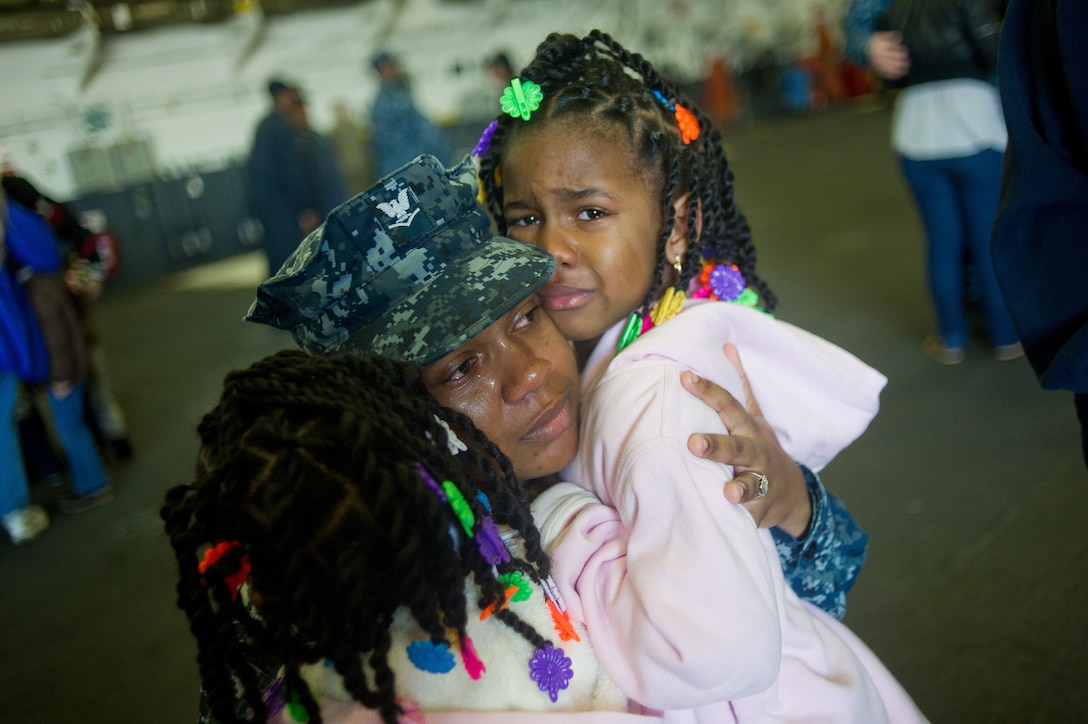 SAN DIEGO - Petty Officer 3rd Class Haadi M. Turner hugs her children goodbye aboard USS Makin Island here Nov. 14. Turner, 25, is from Gaitier, Miss., and serves as an operations specialist with USS Makin Island. Marines and sailors with the 11th Marine Expeditionary Unit, Amphibious Squadron 5 and USS Makin Island in San Diego beginning a seven-month deployment through the Western Pacific and Middle East regions.