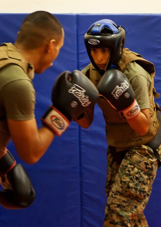 Cpl. Dary N. Bolanos (right), personnel clerk for the administration office at Headquarters and Service Battalion, U.S. Marine Corps Forces, Pacific, spars with Sgt. Corey Etibek, a Marine Corps Martial Arts Program instructor who works at Pacific Command, at the MCMAP room here Nov. 16. The course runs from Nov.14-23 and includes sparring, grappling, sustainment and physical training.