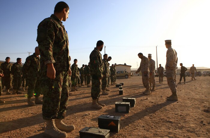 Marines with the Embedded Partnering Team, Combat Logistics Battalion 1, 2nd Marine Logistics Group (Forward), spend the morning showing their Afghan National Army counterparts how to do various Marine Corps exercises on Camp Shorabak, Afghanistan, Nov. 16.  The Marines brought a pull-up bar, soccer ball and weighted ammunition cans for the soldiers to use for physical training.  (U.S. Marine Corps photo by Cpl. Katherine M. Solano)