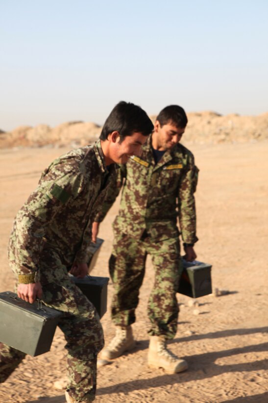 Soldiers with the Afghan National Army 215th Corps Logistics Battalion participate in relay races with weighted ammunition cans brought to them by the Marines with the Embedded Partnering Team, Combat Logistics Battalion 1, 2nd Marine Logistics Group (Forward), on Camp Shorabak, Afghanistan, Nov. 16.  The Marines also brought a hand-built pull-up bar and a soccer ball for the soldiers to use to exercise.  (U.S. Marine Corps photo by Cpl. Katherine M. Solano)