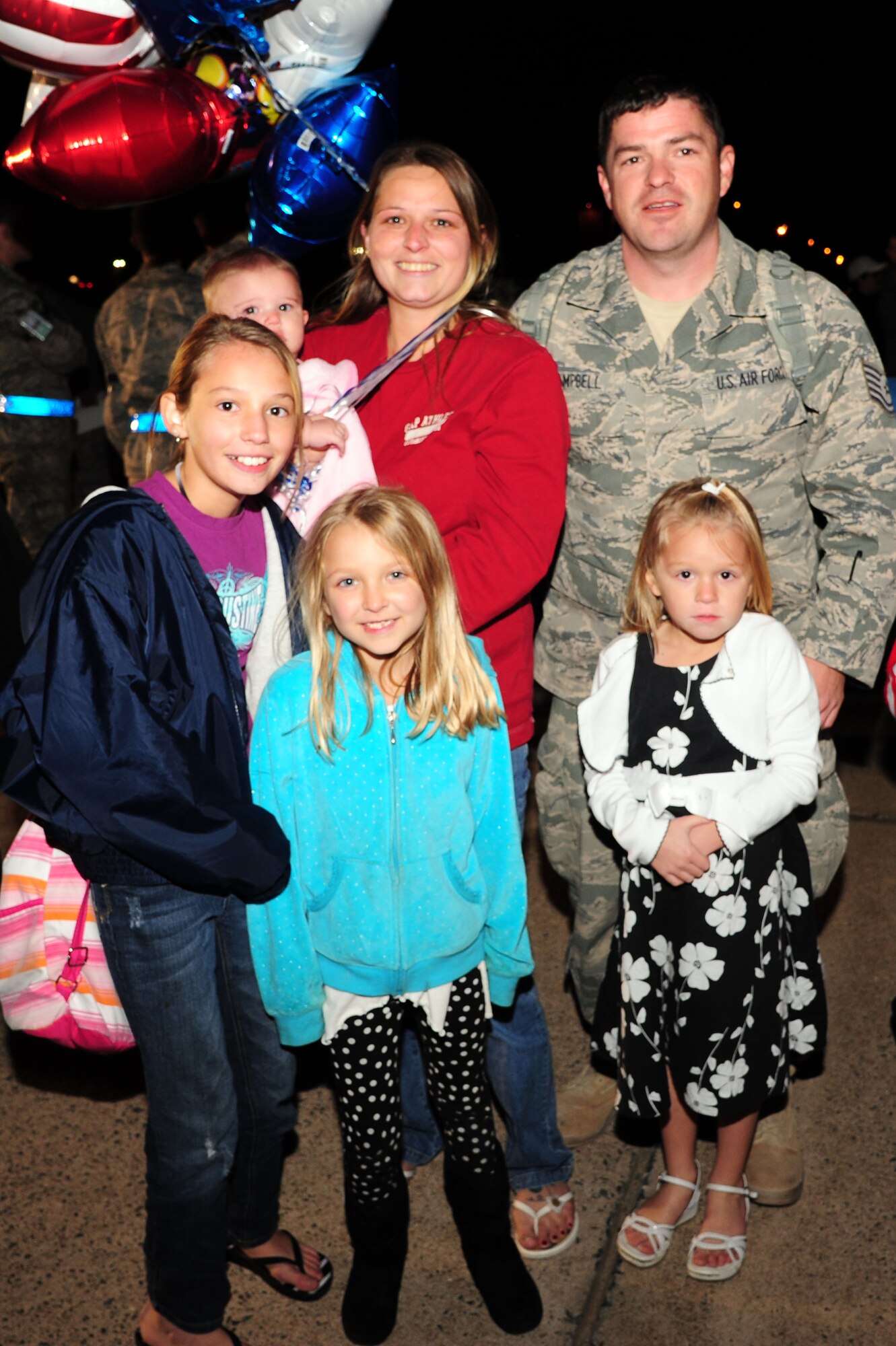 Tech. Sgt. Michael Campbell, a member of the 19th Aircraft Maintenance Squadron, reunites with his wife Donna, and daughters, Jasmine, 10, Danielle, 8, Abby, 6 and Casey 6-months, Wednesday, after being deployed for more than six months. Campbell returned, with nearly 200 other Airmen, from supporting combat operations in Southwest Asia. (U.S. Air Force photo by Airman 1st Class Kaylee Clark)