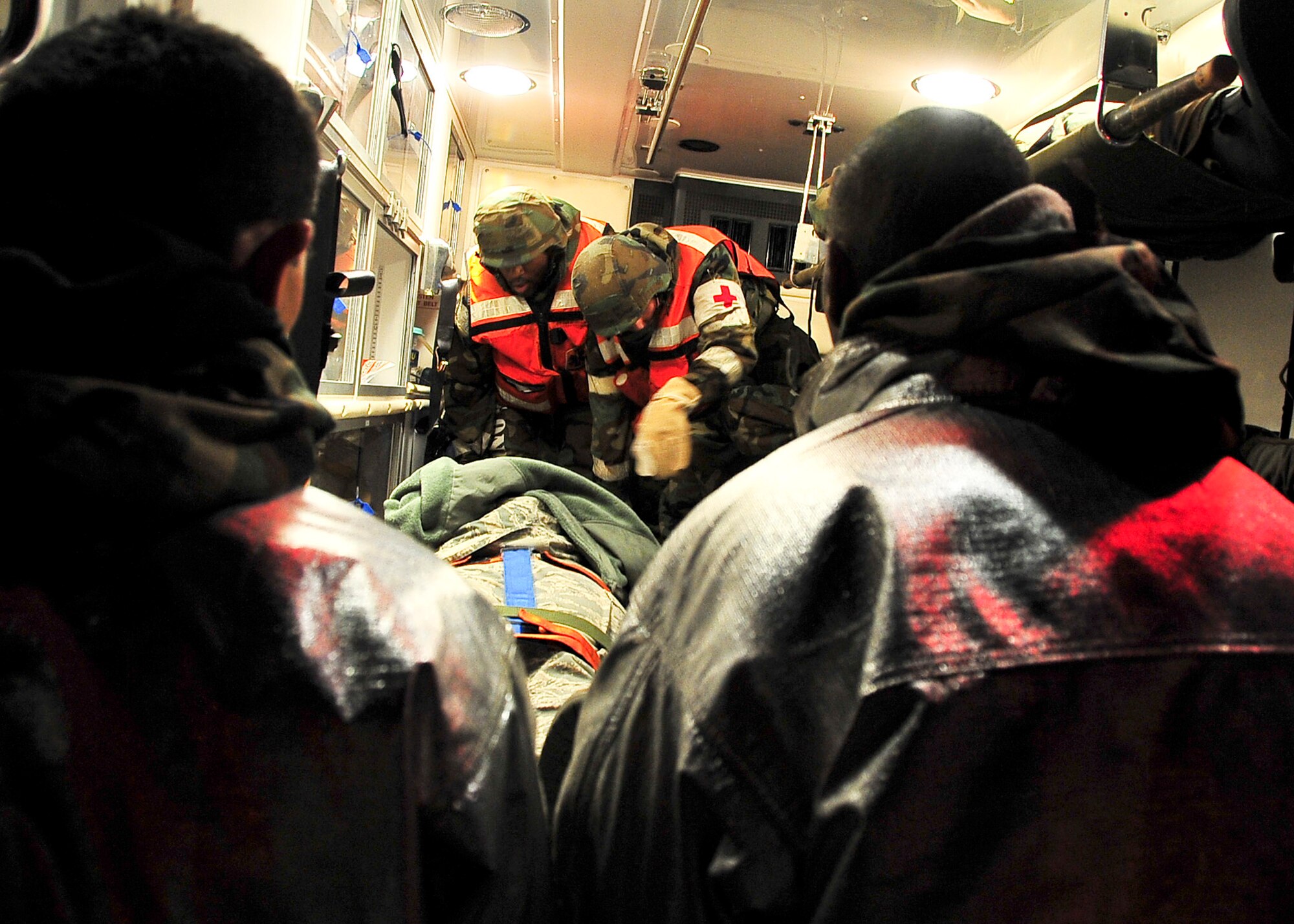 Airmen from both the 51st Aerospace Medicine Squadron and the 51st Civil Engineer Squadron work together to load and transport patients during a simulated place crash during Beverly Bulldog 11-03, a peninsula-wide operational readiness exercise Nov. 14, 2011. This scenario tested the preparedness of Osan responders as well as their abilities to work together to accomplish the mission during Beverly Bulldog 11-03. (U.S. Air Force photos/Senior Airman Adam Grant)