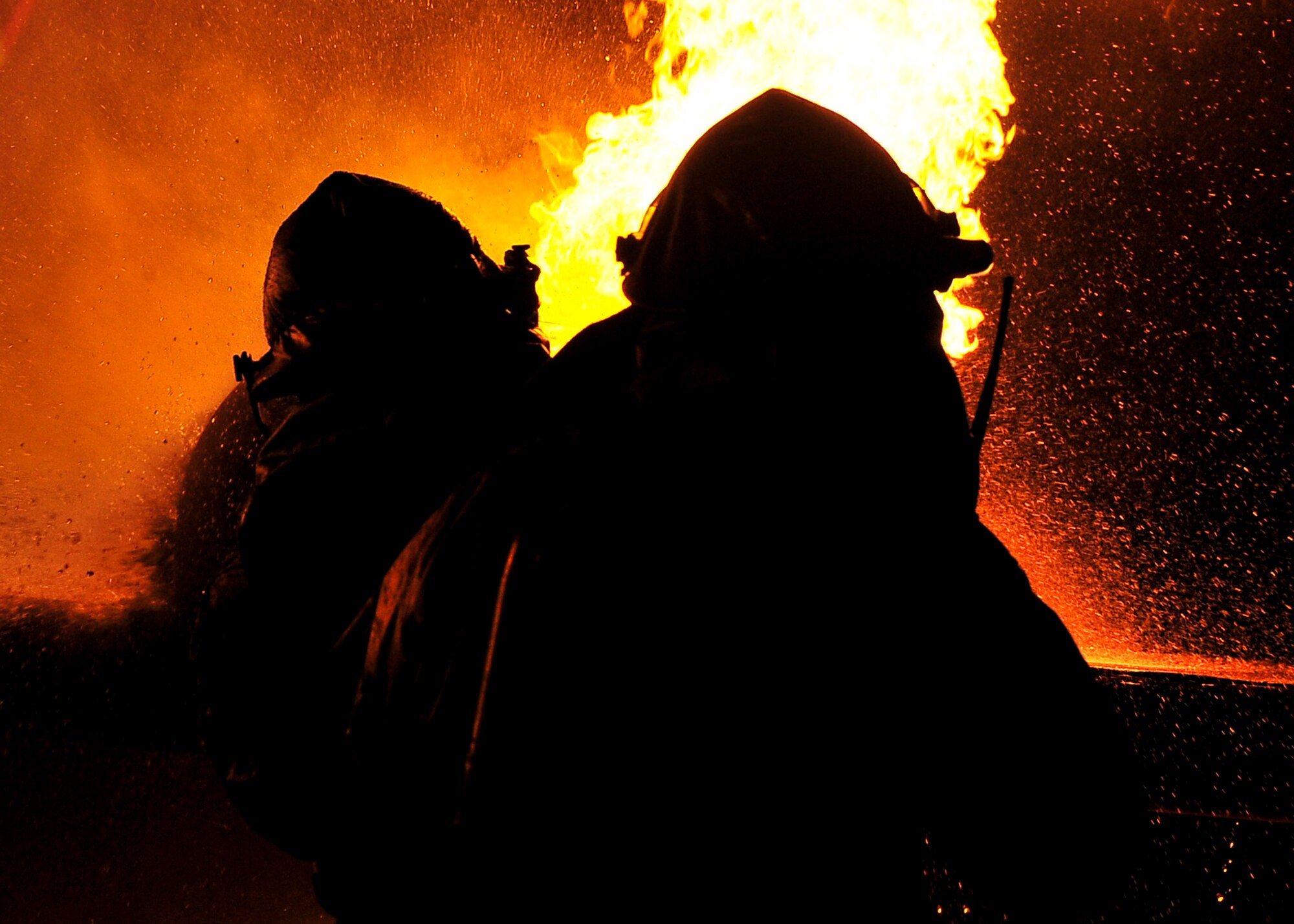 Firefighters from the 51st Civil Engineer Squadron fight a fire after a simulated plane crashed during Beverly Bulldog 11-03, a peninsula-wide operational readiness exercise Nov. 14, 2011. Beverly Bulldog 11-03 scenarios test team Osan’s ability to defend the base and conduct daily operations in a combat environment. (U.S. Air Force photos/Senior Airman Adam Grant)