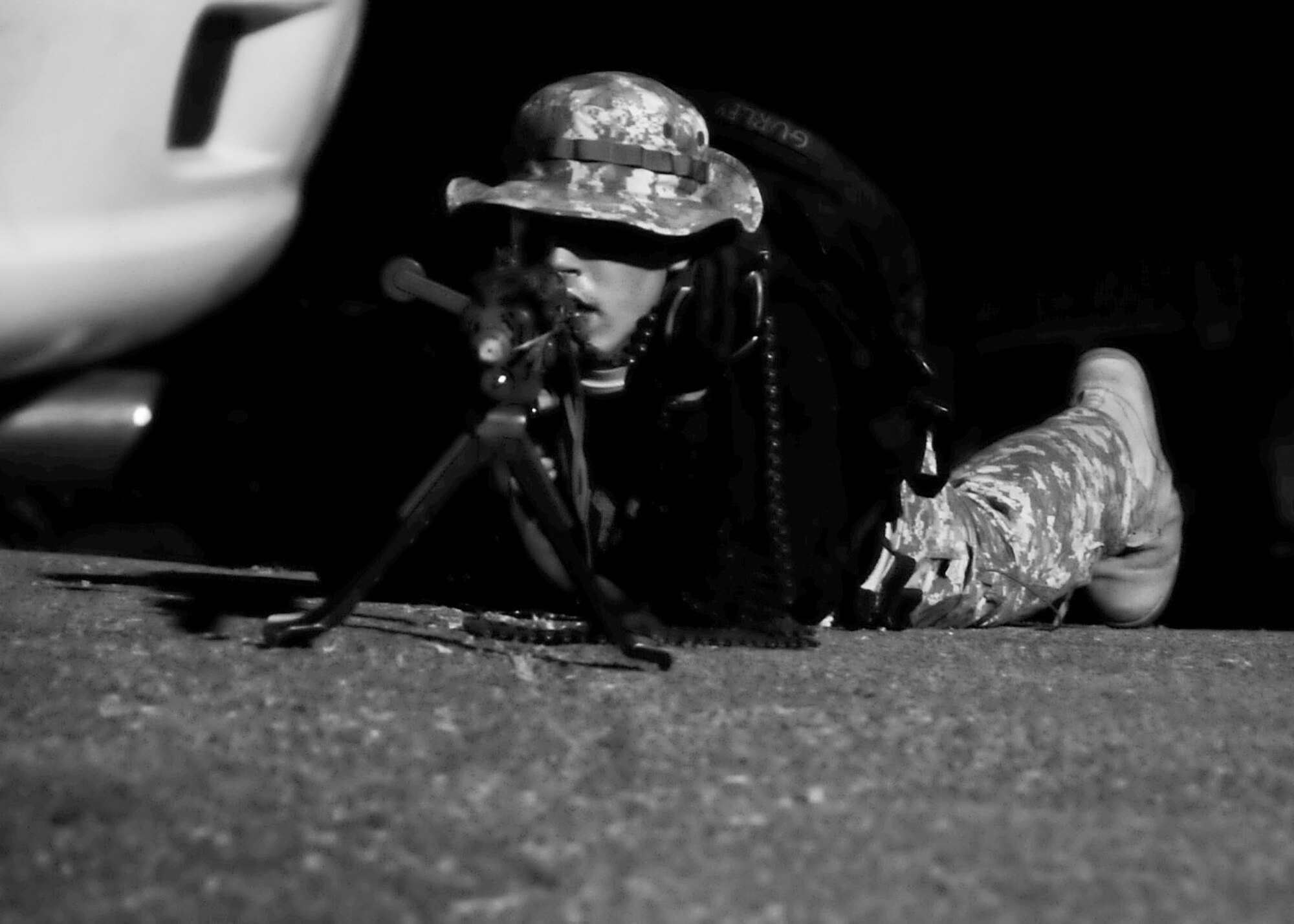 A member of the Opposing Force lays and waits for his opportunity to ambush members of the 51st Security Forces Squadron during Beverly Bulldog 11-03, a peninsula-wide operational readiness exercise Nov. 15, 2011. This scenario tested the preparedness of Osan responders as well as their abilities to work together to accomplish the mission during Beverly Bulldog 11-03. (U.S. Air Force photos/Senior Airman Adam Grant)