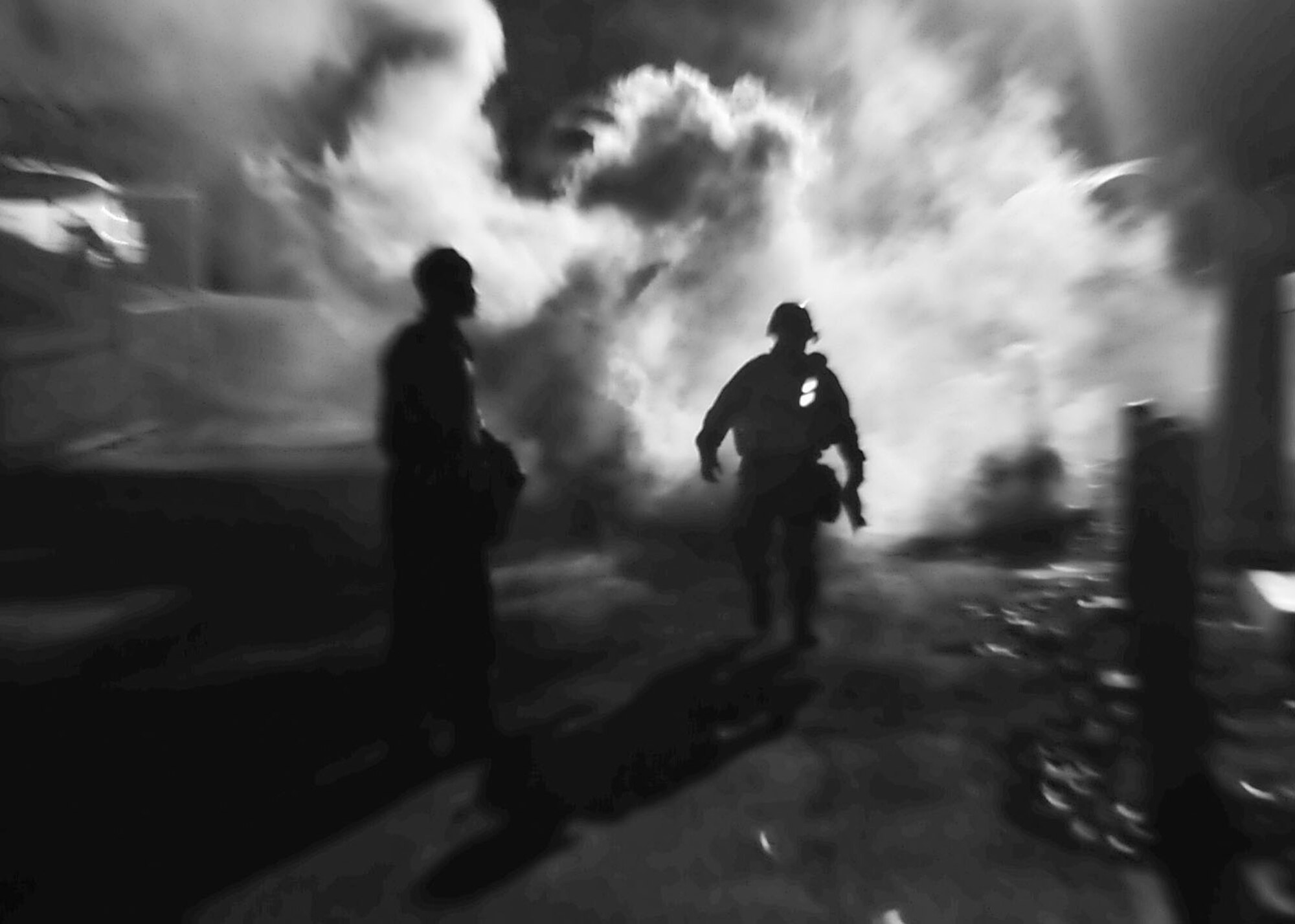 Members of the 51st Fighter Wing evaluation team walk away after throwing a smoke grenade Nov. 15, 2011, during Beverly Bulldog 11-03, a peninsula-wide operational readiness exercise. The exercise allows Airmen to demonstrate their ability to complete the mission in a simulated hostile environment while executing their primarily duties. (U.S. Air Force photos/Senior Airman Adam Grant)