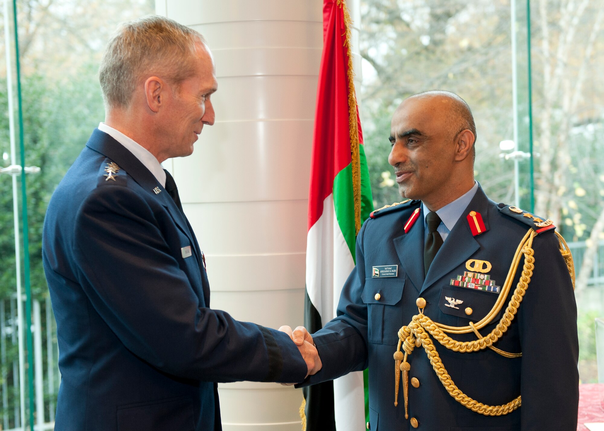 U.S. Air Force Gen. Mike Hostage III, is congratulated by the United Arab Emirates (UAE) Air Attaché Col. Abdelrahmn Al-Mazmiby after presenting the Foreign Operations Missions Medal to the general during a ceremony at the UAE Embassy, Washington D.C. on Nov. 15, 2011. (U.S. Air Force photo by Jim Varhegyi/Released)