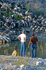 LAUGHLIN AIR FORCE BASE, Texas – Danny Yandell (left), and Gene Moore (right), both of the 47th Civil Engineering Squadron, look at thousands of tires washed up along Lake Amistad Sept. 2. The old WWII Jeep tires were installed in the marina decades ago by the Army Corps of Engineers to protect the marina from high winds. Powerful storms throughout the last 30 years damaged the structure and ultimately gave way in 2011, littering the shorelines. (U.S. Air Force photo/Senior Airman Scott Saldukas)