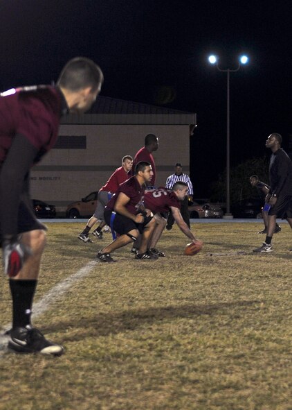Pedro De Los Santos, 23rd Medical Group center, prepares to hike the ball during an intramural flag football champion game at Moody Air Force Base, Ga., Nov. 10, 2011. The 23rd MDG team was the 2010 Moody Air Force Base flag football champions. This was their second year in a row competing for the title. (U.S. Air Force photo by Airman 1st Class Olivia Dominique/Released)