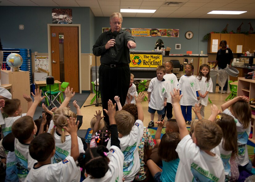 Greg Allen, The Magic of Recycling presenter, chooses volunteers for an interactive magic trick which demonstrates the effects of recycling and not recycling at the Child Development Center, Moody Air Force Base, Ga., Nov. 16, 2011. Allen visited the CDC to educate children on the importance of recycling in hopes that it becomes second nature for them when they grow up. He is scheduled to travel to approximately 12 more schools in Lowndes County to perform his recycling presentation. (U.S. Air Force photo by Senior Airman Eileen Meier/Released)