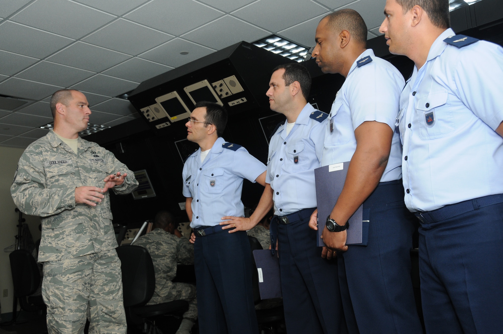 Chief Master Sgt. Richard Boulanger, 334th Training Squadron, briefs officer students Davi Medeiros, Flavio Diniz, Aramys Baptista, Carlos Mendes, and Edson Rodrigues, Brazilian Air Force, during a tour of the air traffic control school at Cody Hall, Keesler Air Force, Base, Miss., Nov. 16, 2011.  Members of the Brazilian Air Force also toured base operations and ate lunch at Bay Breeze Event Center.  Brig. Gen. Andrew Mueller, 81st Training Wing commander, noted Keesler’s cooperation with the Brazilian military over the past 67 years.  Brazilian soldiers completed aircraft mechanics courses At Keesler beginning in 1944.  (U.S. Air Force photo by Kemberly Groue)