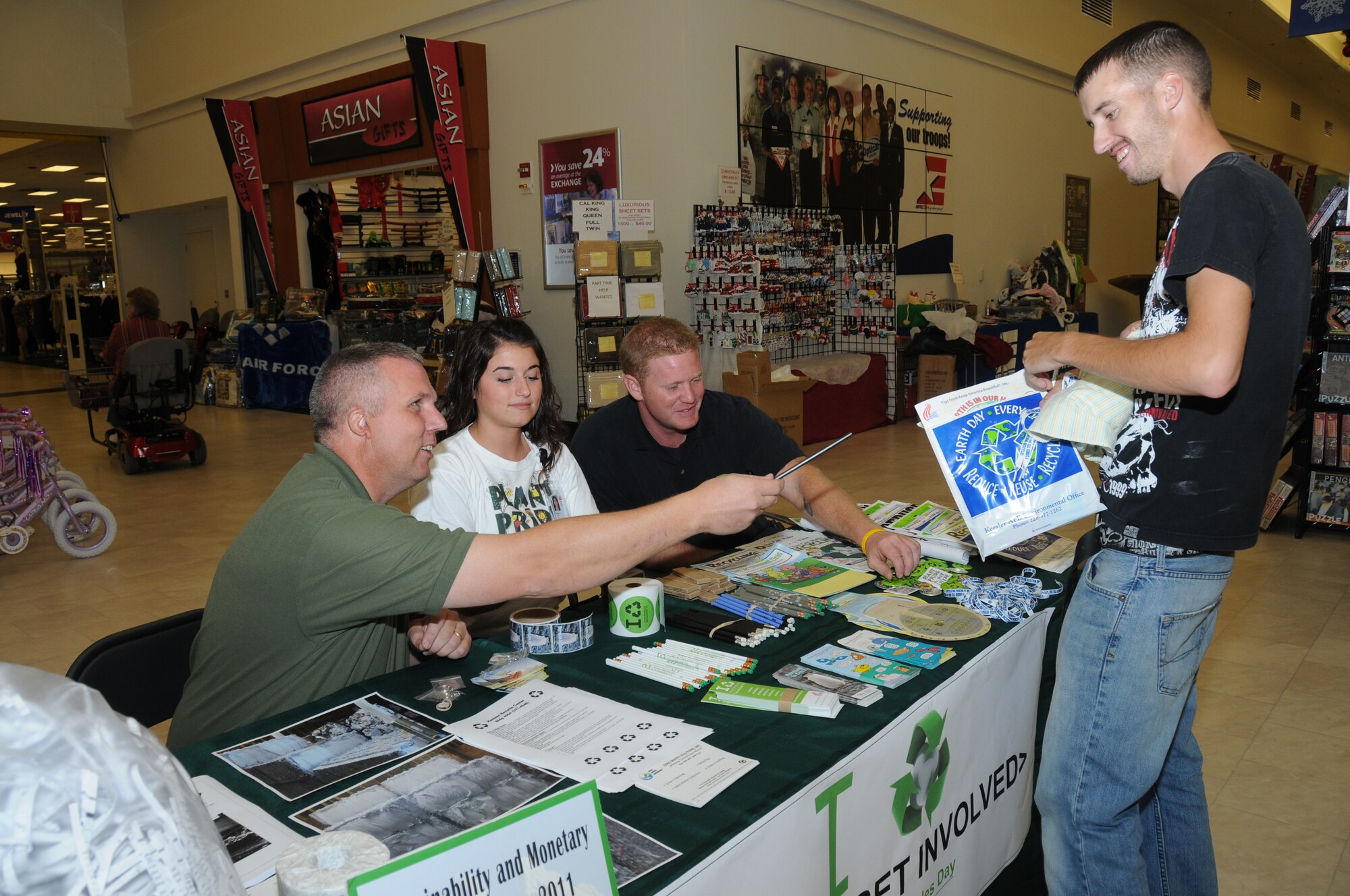 Petty Officer 3rd Class Anthony Moye, Naval Mobile Construction Battalion 7, Gulfport, Miss., receives recycling handouts Nov. 15, 2011, at the base exchange, Keesler Air Force Base, Miss., from Douglas Smith, contractor for Zero Waste Solutions at the Keesler Recycling Center and Amanda O’Neal and Aaron Carter, Lanier Environmental.  The booth was on display to promote America Recycles Day.  (U.S. Air Force photo by Kemberly Groue)
