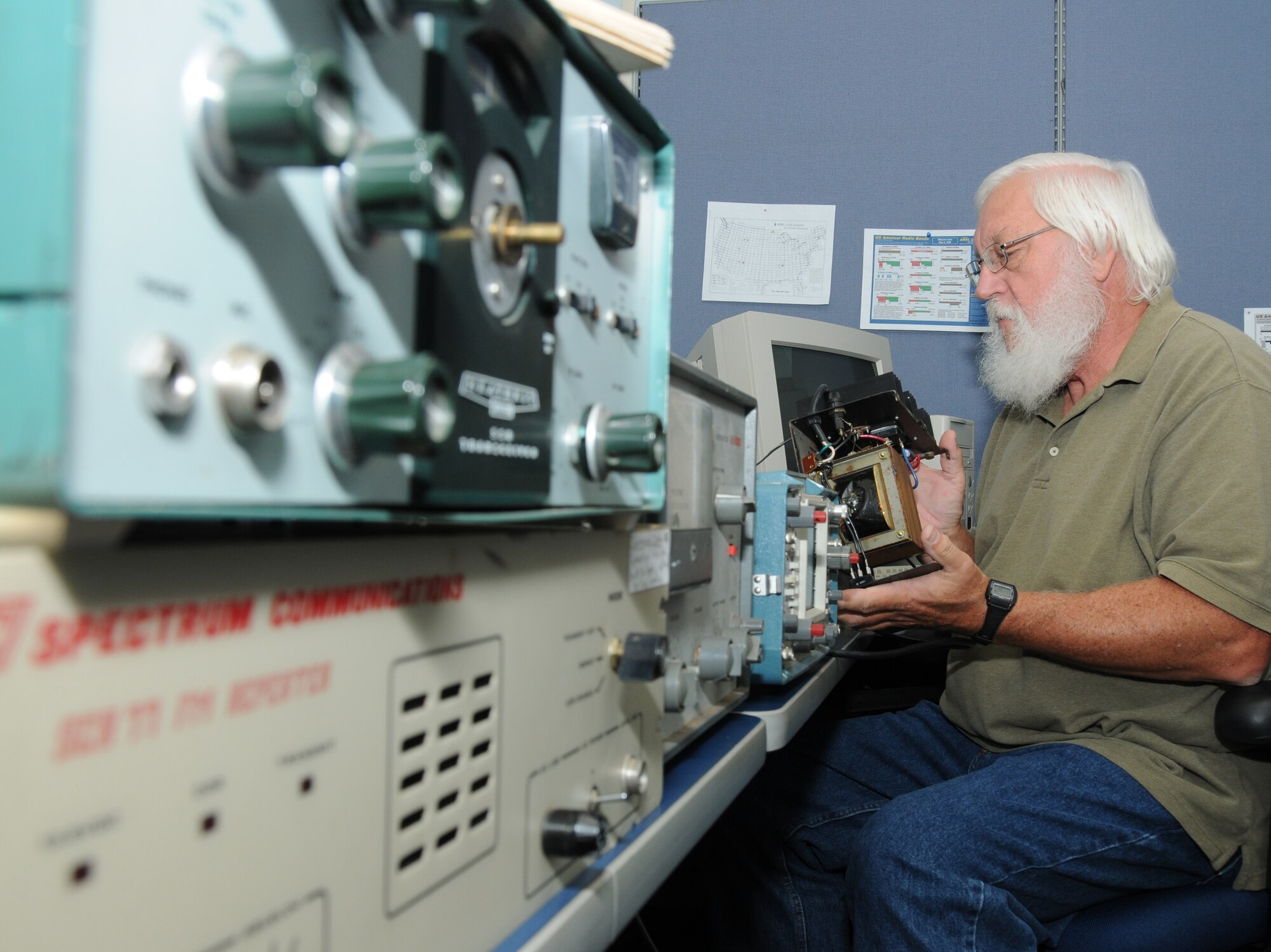 Harry Samuelson, president of the Keesler Amateur Radio Club, inspects the power supply of various antique radio equipment Nov. 7, 2011 at Keesler Air Force Base, Miss.  There are currently six club members.  (U.S. Air Force photo by Kemberly Groue)