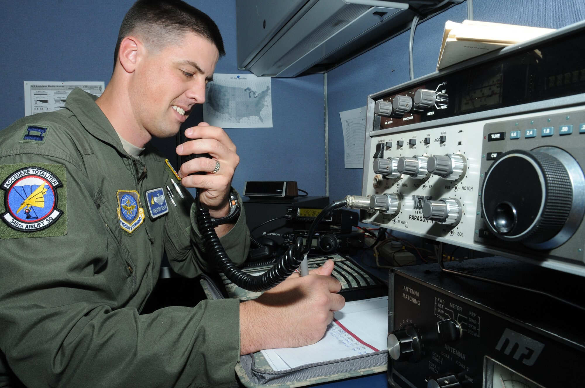 Capt. Trenton Selah, 345th Airlift Squadron, attempts to communicate using a ten-tec high frequency transceiver while logging his efforts at the Locker House, Keesler Air Force Base, Miss., Nov. 7, 2011.  Selah is a member of the Keesler Amateur Radio Club that meets 7 p.m. the second Monday of the month in Rooms 5438 and 5439, Locker House, KAFB.  (U.S. Air Force photo by Kemberly Groue)