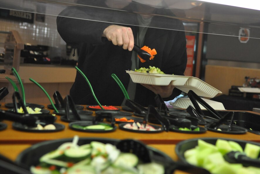 An Airman serves himself salad at the Olympic Dining Facility on Joint Base Lewis-McChord, Wash. The formula to weight loss isn't a secret: Burn more calories than you eat, or eat less than you burn. According to the President's Council on Physical Fitness and Sports, roughly three out of five Americans carry an unhealthy amount of excess weight. (U.S. Air Force photo/Airman 1st Class Leah Young)