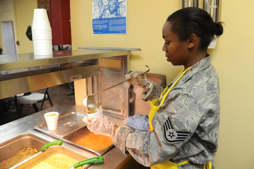 Staff Sgt. Courtney Richardson prepares a cup of soup during lunch at the Community Soup Kitchen in Goldsboro, N.C., Nov. 10, 2011. Richardson is a member of Group 56, which aims to provide mentorship and guidance for future leaders of the U.S. Air Force. Richardson is the 4th Fighter Wing public affairs NCOIC of photojournalism and a native of New Bern, N.C. (U.S. Air Force photo by Senior Airman Whitney Stanfield)